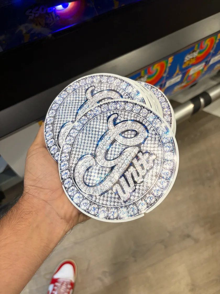 Hand holding a circular silver printed package